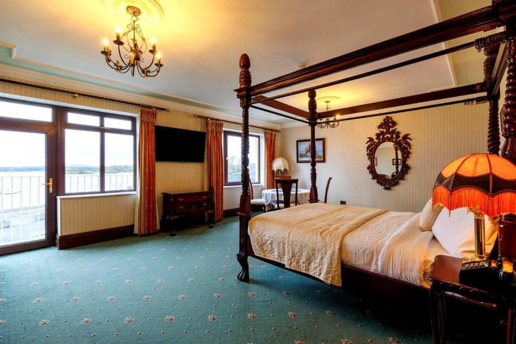 a bedroom with a canopy bed and a large window at Lakeside Manor Hotel in Virginia