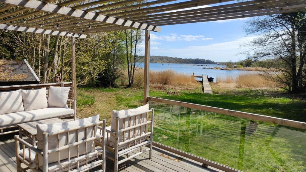 a porch with two chairs and a view of a lake at Haus Hav in Ronneby