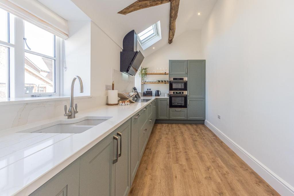 a kitchen with a sink and a counter top at Stretton Lower hall in Malpas