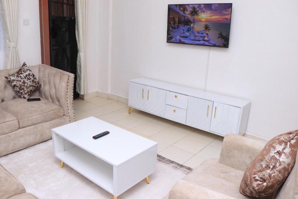 a living room with a couch and a coffee table at Makenahluxuries Embu Paradise Apartment near Java Gakwegori in Kangaru