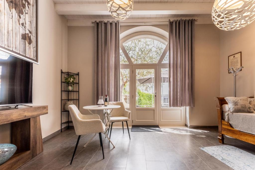 a living room with a table and chairs and a window at Corte Lavarini in Fumane