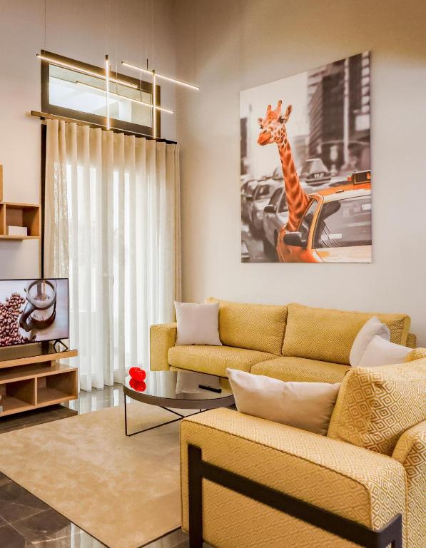 a living room with a couch and a giraffe in a car at Urban Apartments in Chios