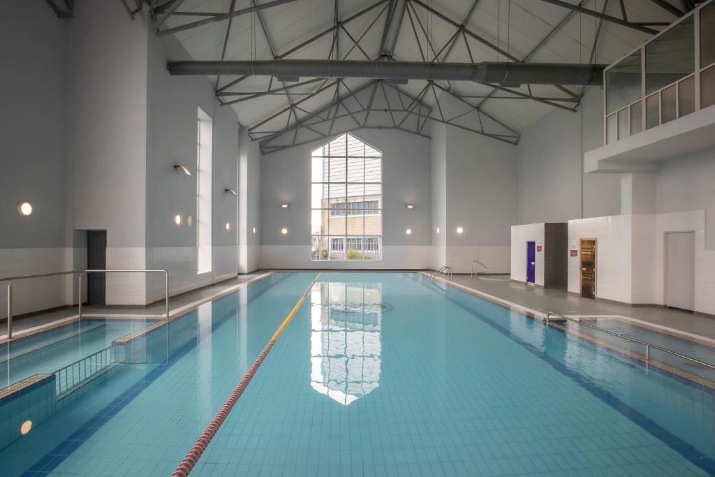 a large swimming pool in a large building at Maldron Hotel & Leisure Centre, Oranmore Galway in Oranmore