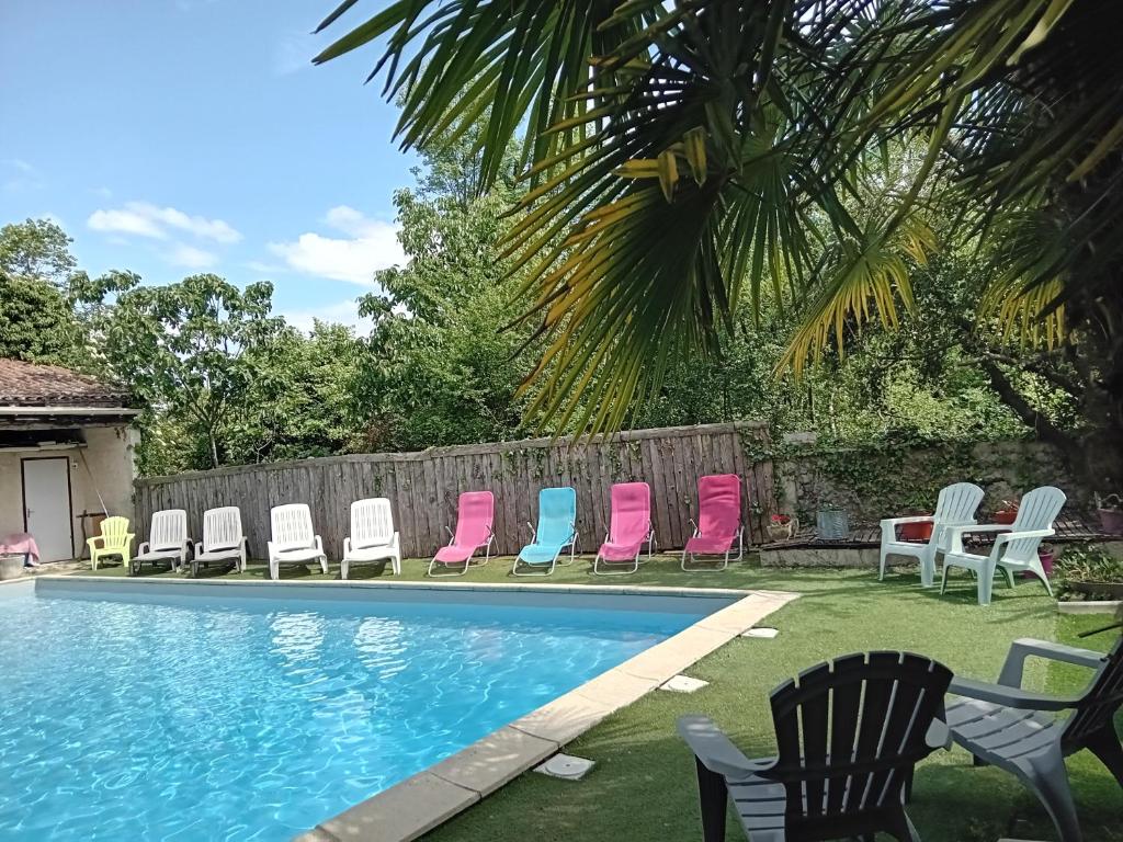 a group of chairs sitting next to a swimming pool at Hôtel La Gravenne in Thueyts