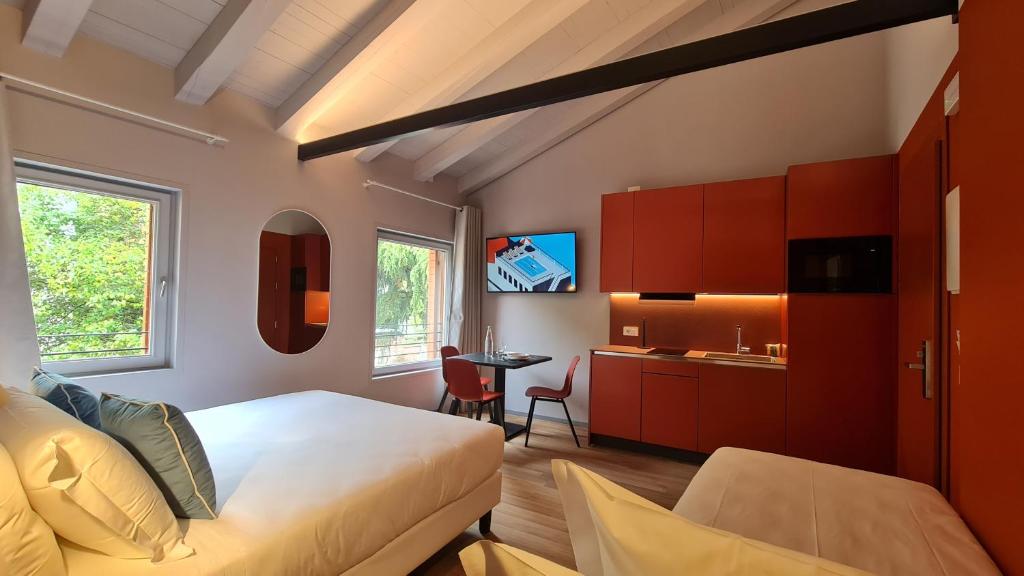 a bedroom with a bed and a kitchen with a table at Michelangelo House, your personal Studio in Mestre