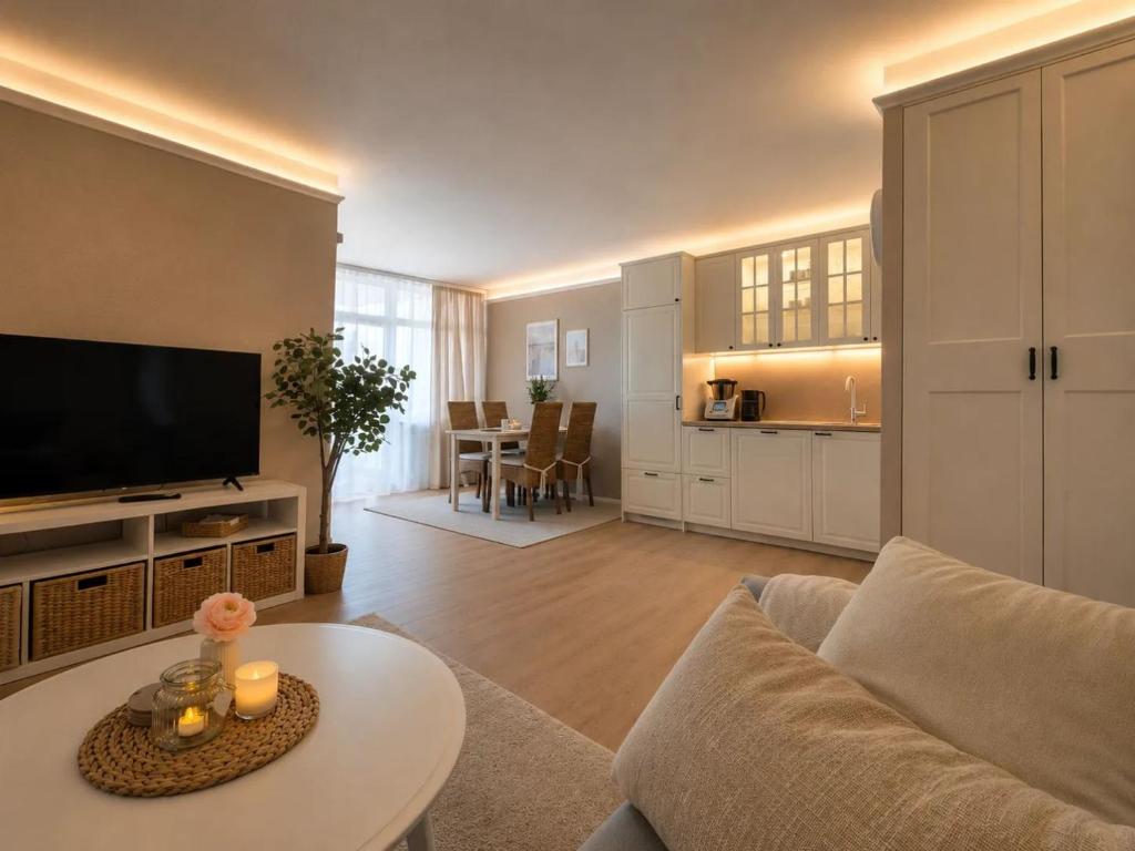 a living room with a couch and a table at MareTime - inkl Wäschepakete, 50m zum Strand in Pelzerhaken