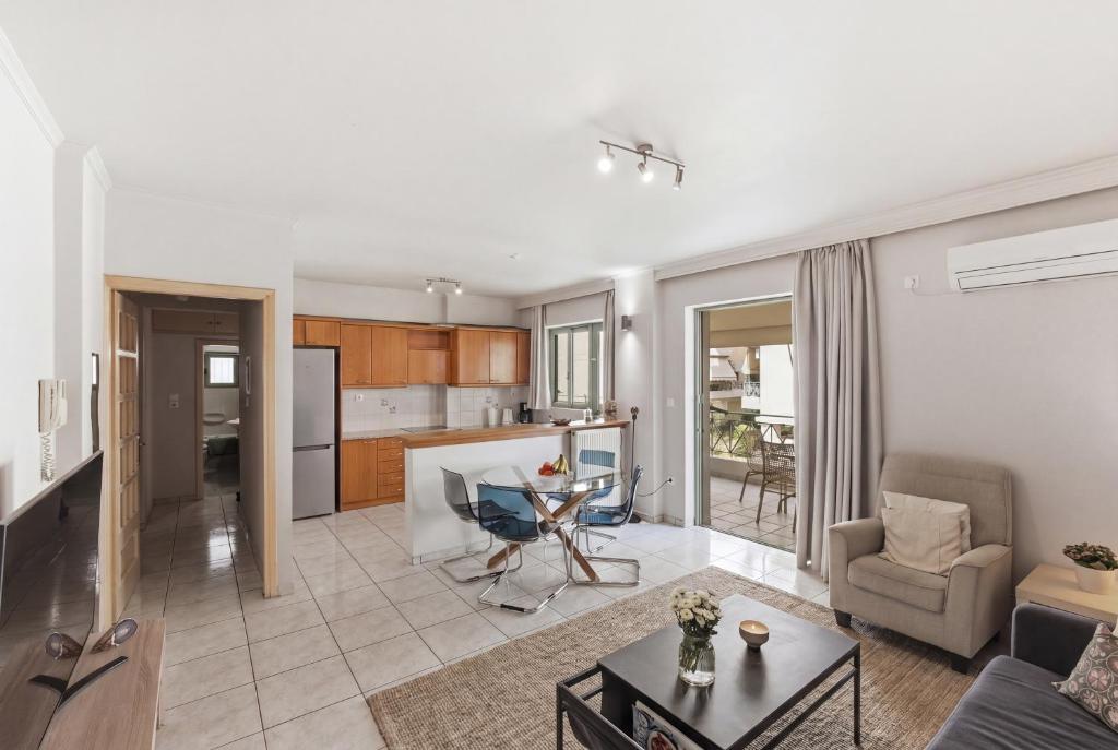 a living room and kitchen with a couch and a table at Moschato-Niarchos modern apartment in Piraeus