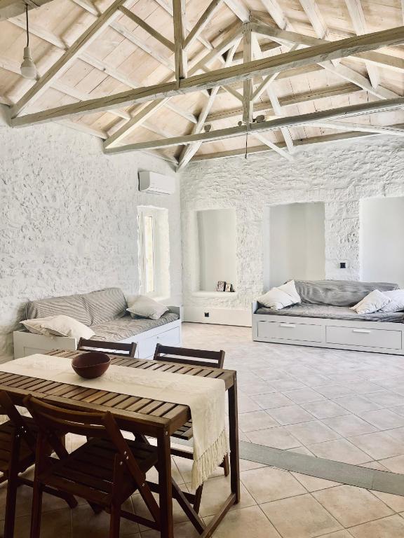 a living room with a table and a couch at Anna home Elafonisos in Elafonisos