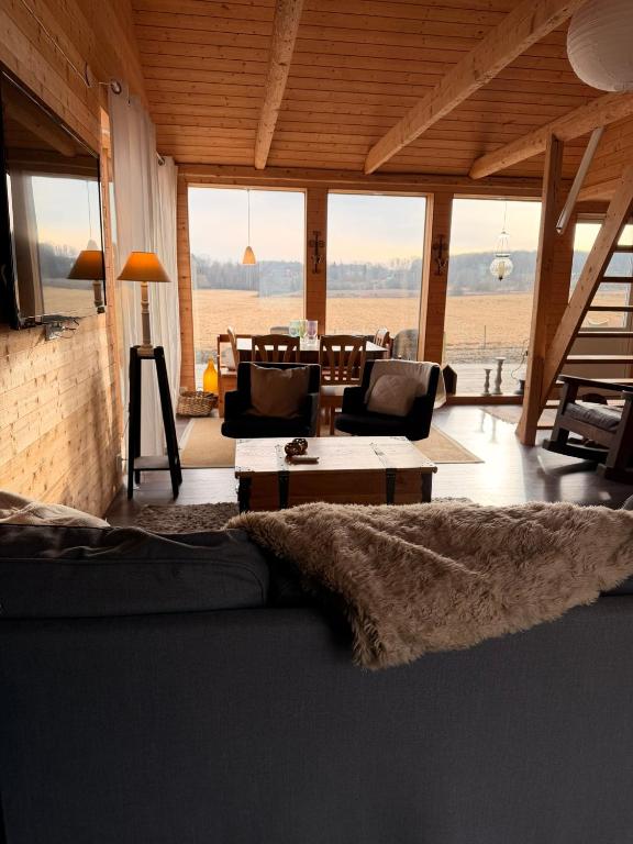 a living room with a couch and a table at Bergsbo Lodge in Halmstad