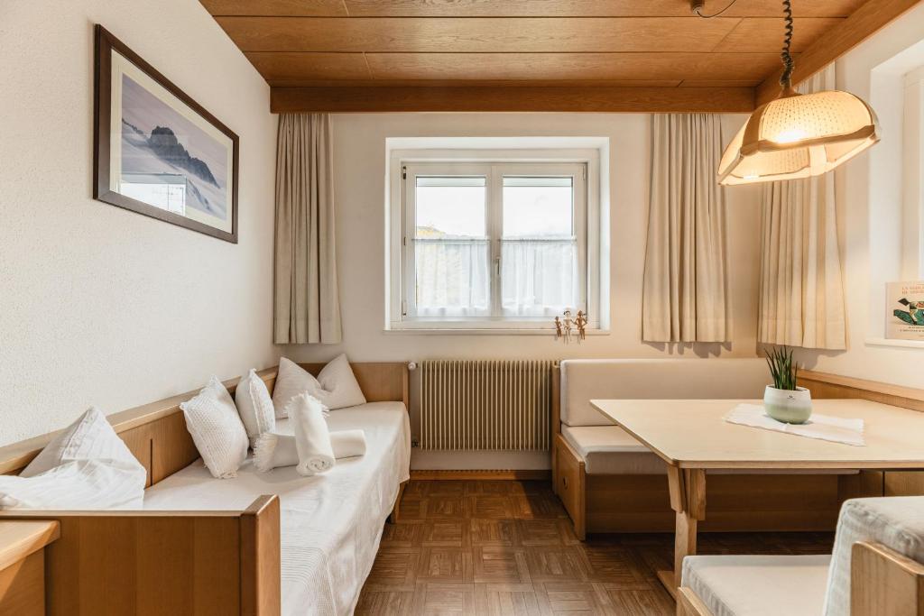 a living room with a couch and a table at Apartments Chalet Zirm in Santa Cristina Gherdëina