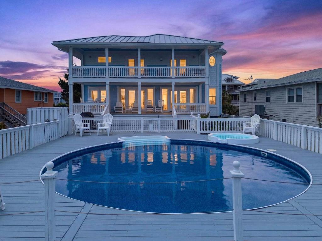 a house with a swimming pool on a deck at SEA2SKY Ocean front private pool and spa in Kure Beach
