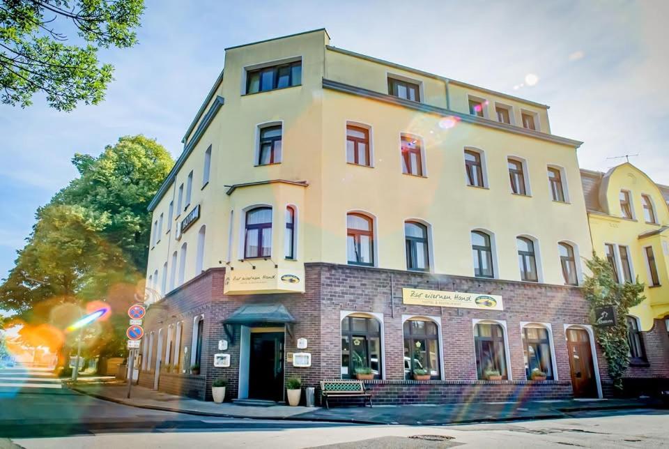 a tall white building on a city street at Hotel Restaurant Zur Eisernen Hand in Viersen