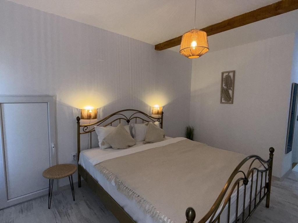 a bedroom with a large bed and a lamp at Cazare Vidin in Basarabi