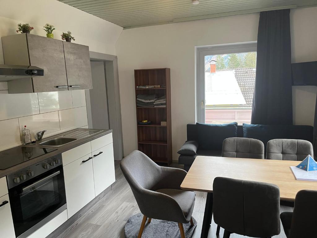 a kitchen and living room with a table and chairs at Flying Hirsch in Stall