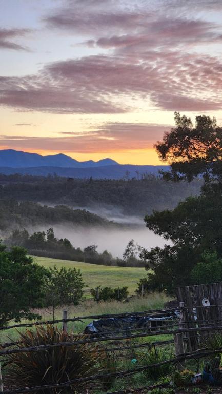a view of a foggy field with the sunset in the background at Kairos Vista in Sedgefield