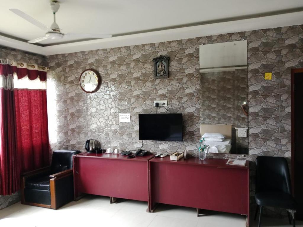 a hotel room with a reception desk and a television at countryside view hotel Silchar in Silchar