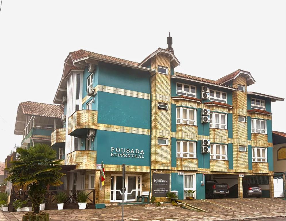 a building with a sign on the front of it at Pousada Ruppenthal in Canela