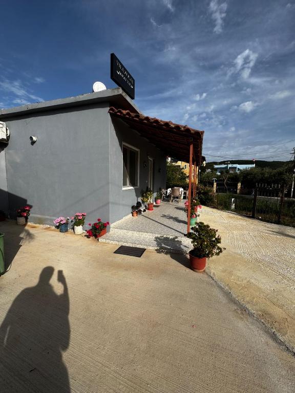 a shadow of a person taking a picture of a building at Erik Studio in Ksamil