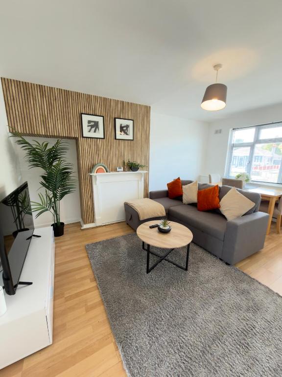 a living room with a couch and a table at Contractor & Family Haven, Sleeps 7, Parking & Garden in Wednesfield