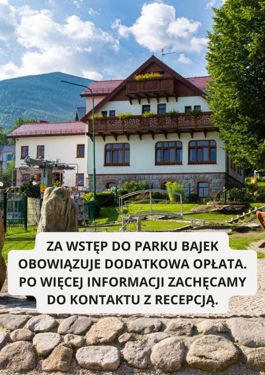 a building with a sign in front of it at Przystanek Bavaria - Sauny i parking w cenie! in Karpacz