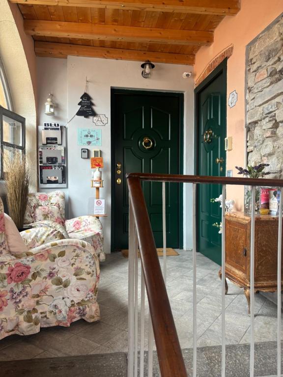 a living room with a green door and a couch at Storico in Como