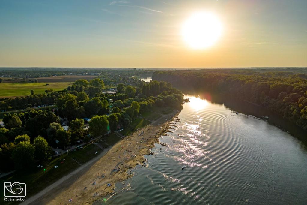 an aerial view of a river with the sun in the sky at Panoráma Szálláshely in Csongrád