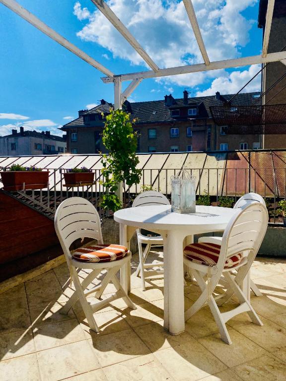 a white table and two chairs on a patio at L'escale vosgienne in Saint Die