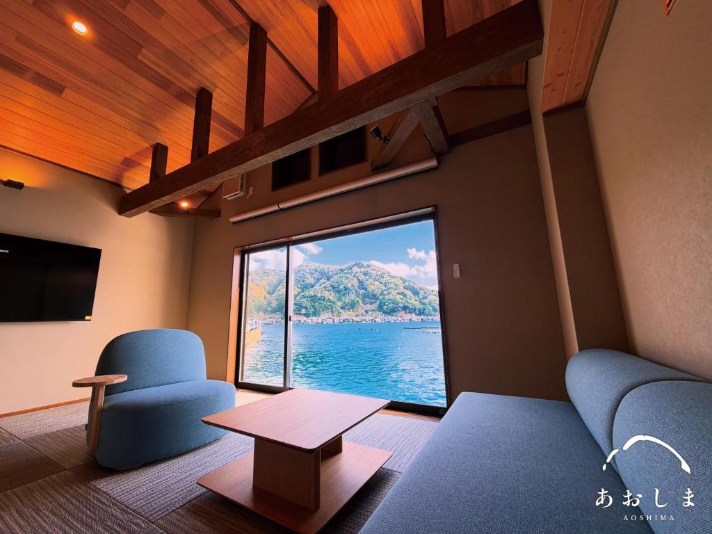 a living room with a view of the water at Aoshima あおしま in Kameshima