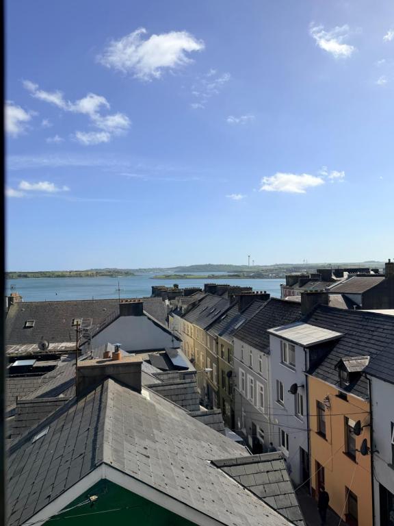 a view of a city with buildings and the water at The Rock House in Cobh