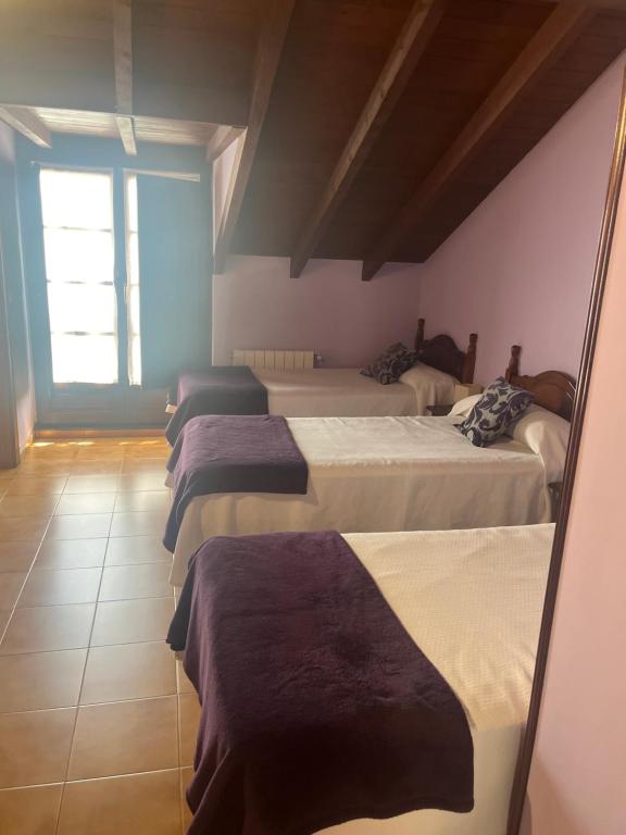 a group of four beds in a room at hosteria de Boo in Boó de Piélagos