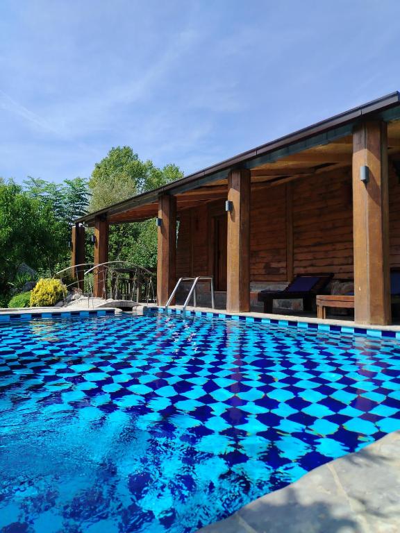 a swimming pool in front of a house at Forest Home 2 in Železnička Stanica )) (( Gornja Plavnica