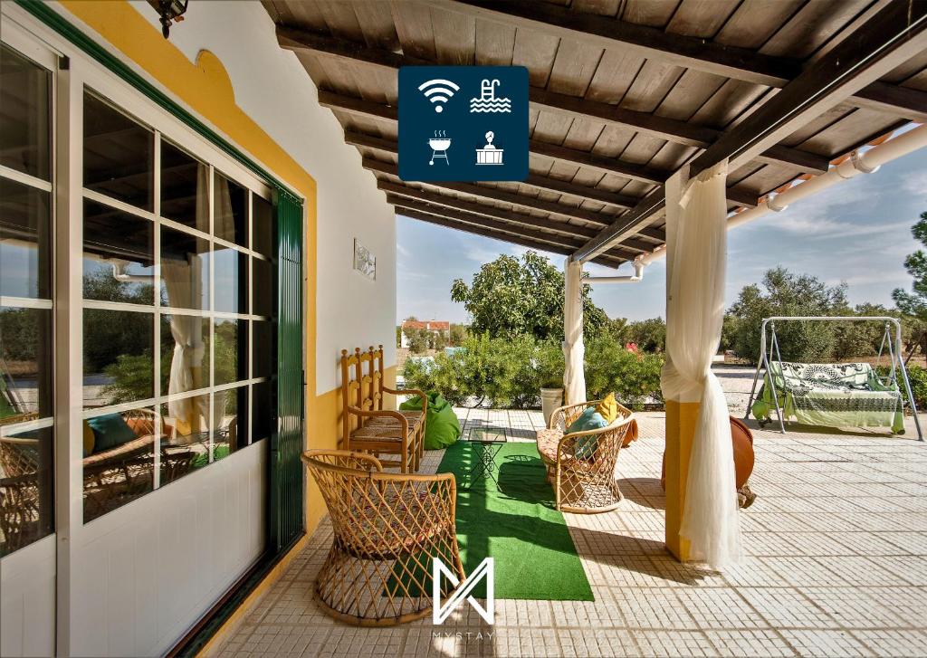 a patio with chairs and a gazebo at MyStay - Monte dos Abrunhos in Vimieiro