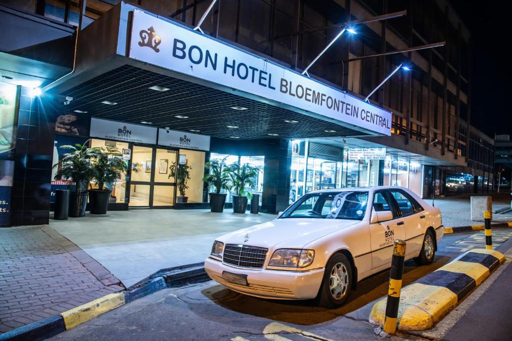 a car parked in front of a building at night at BON Hotel Bloemfontein Central in Bloemfontein