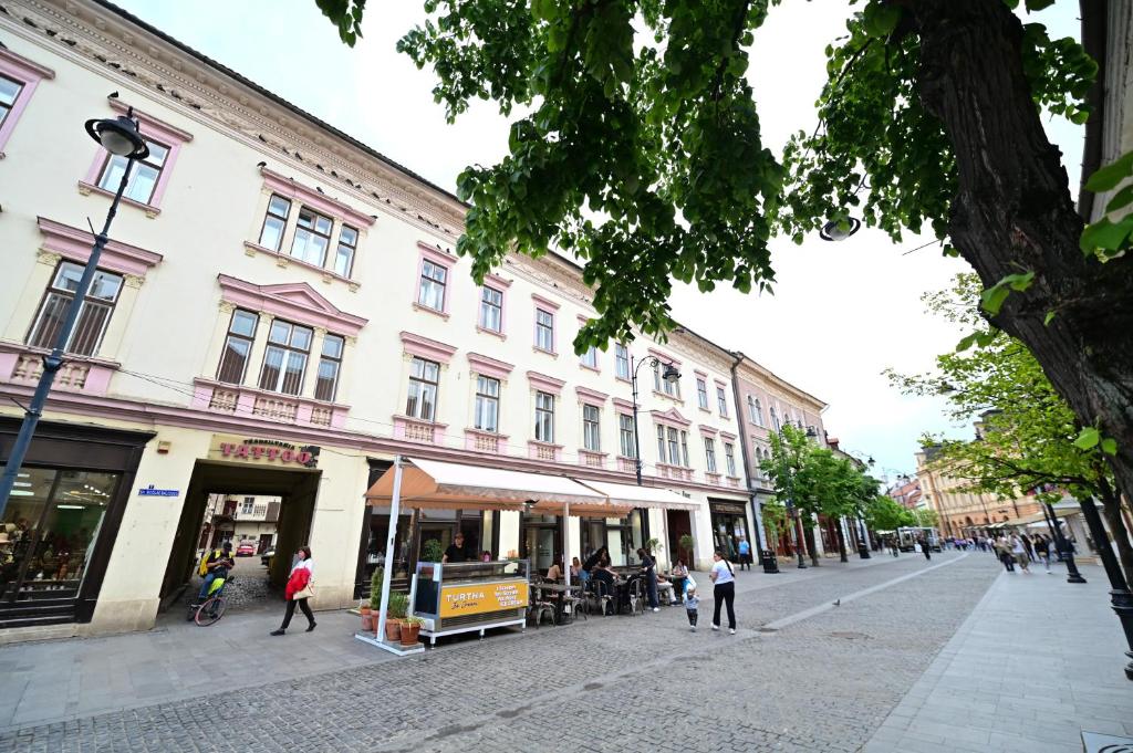 a group of people walking on a city street at FLH - Brukenthal Studios - Old Town in Sibiu