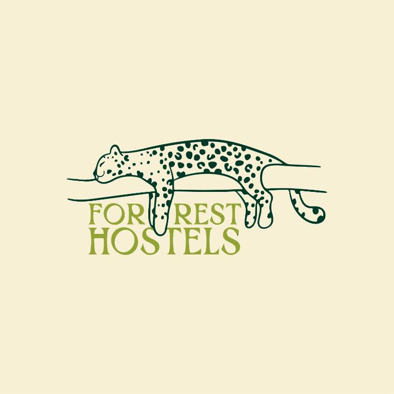 a leopard on a branch forrest fossils logo at Forrest Hostels in Mumbai
