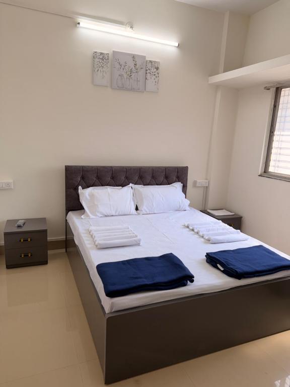 a bedroom with a large bed with two towels on it at Swami Homestay in Solapur