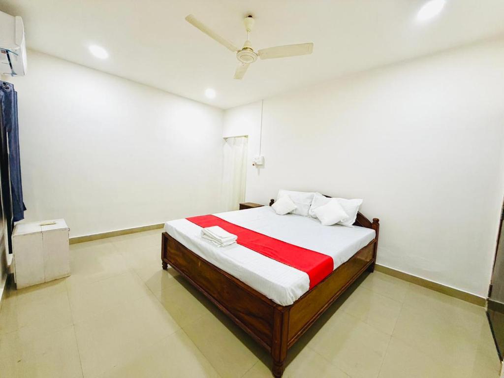 a bedroom with a bed with a red blanket at Raj Garden Resort in Guwahati