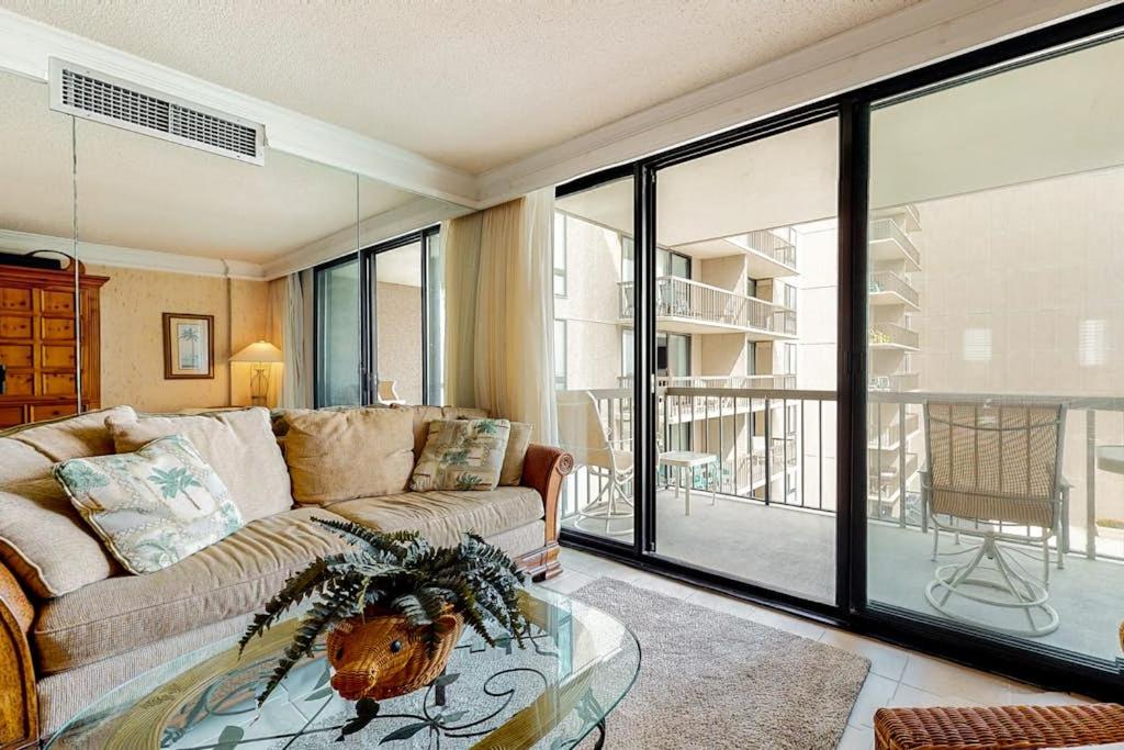 a living room with a couch and a glass table at Sea Colony oceanfront 4th floor condo with elevator in Bethany Beach