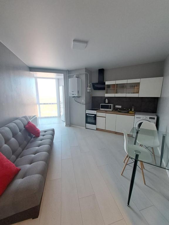 a living room with a couch and a kitchen at Яровиця 9699 in Lutsk