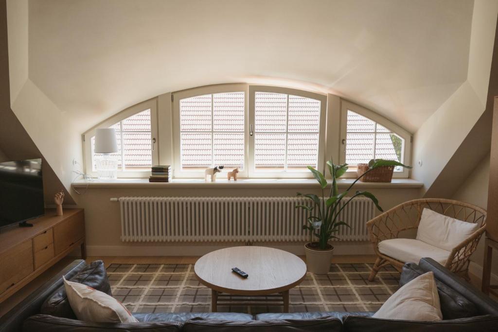 a living room with a couch and a large window at JETHON Appartement am Wasserturm 1 in Nienburg