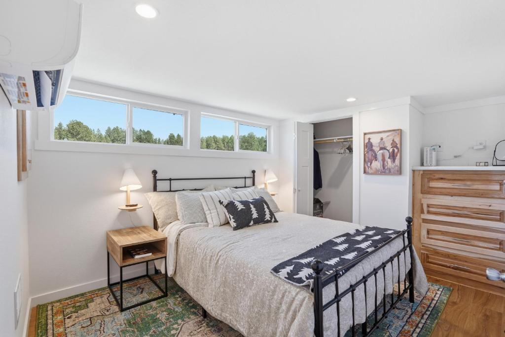 a white bedroom with a bed and a window at Huckleberry Inn in Custer
