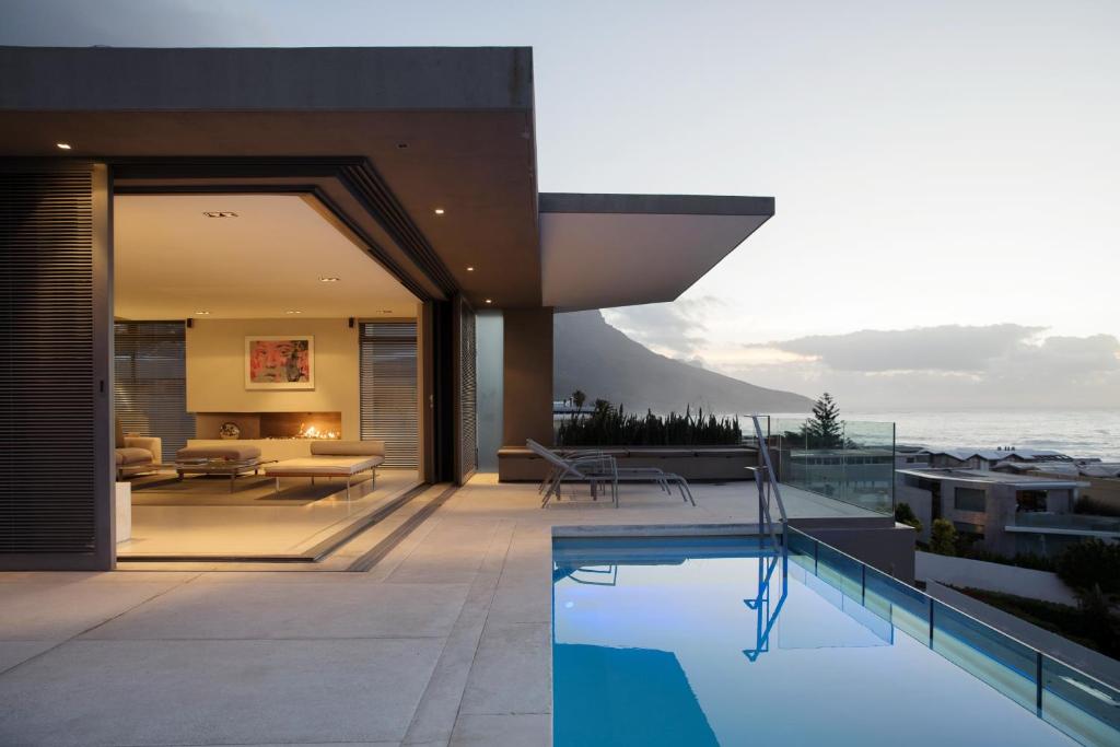 a house with a swimming pool on a balcony at Blue Views Villas and Apartments in Cape Town