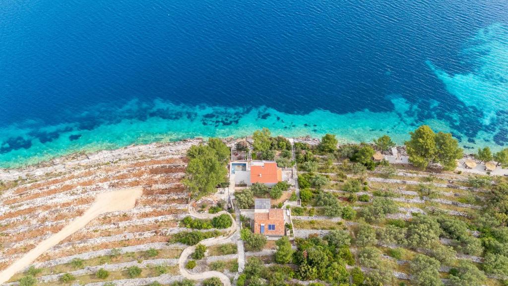 an aerial view of a house next to the water at House Vers in Vela Luka