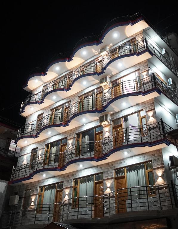 a tall building with balconies and lights on it at Hotel Arijika View in Kullu Manali