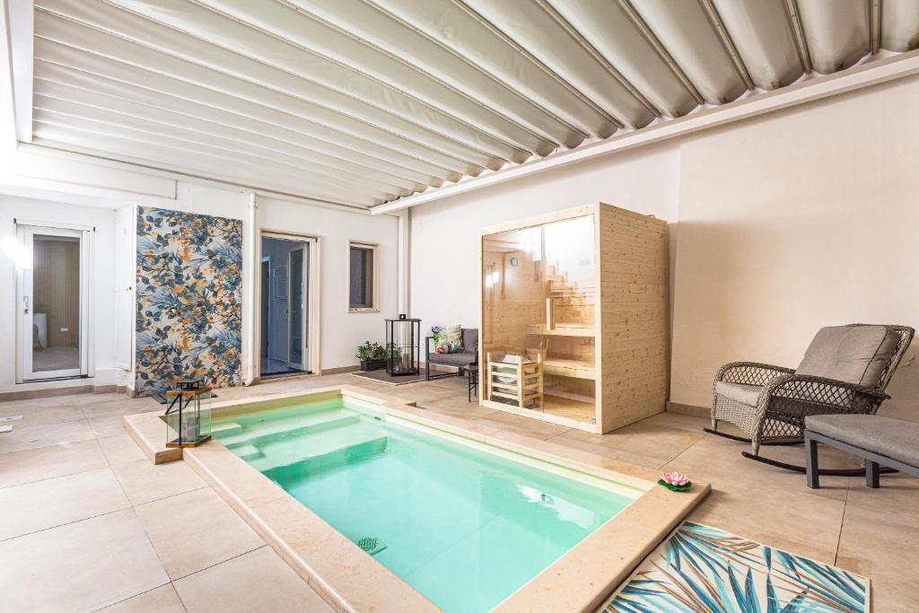 a living room with a swimming pool in a house at Pasitea Luxury Suite by BarbarHouse in Squinzano