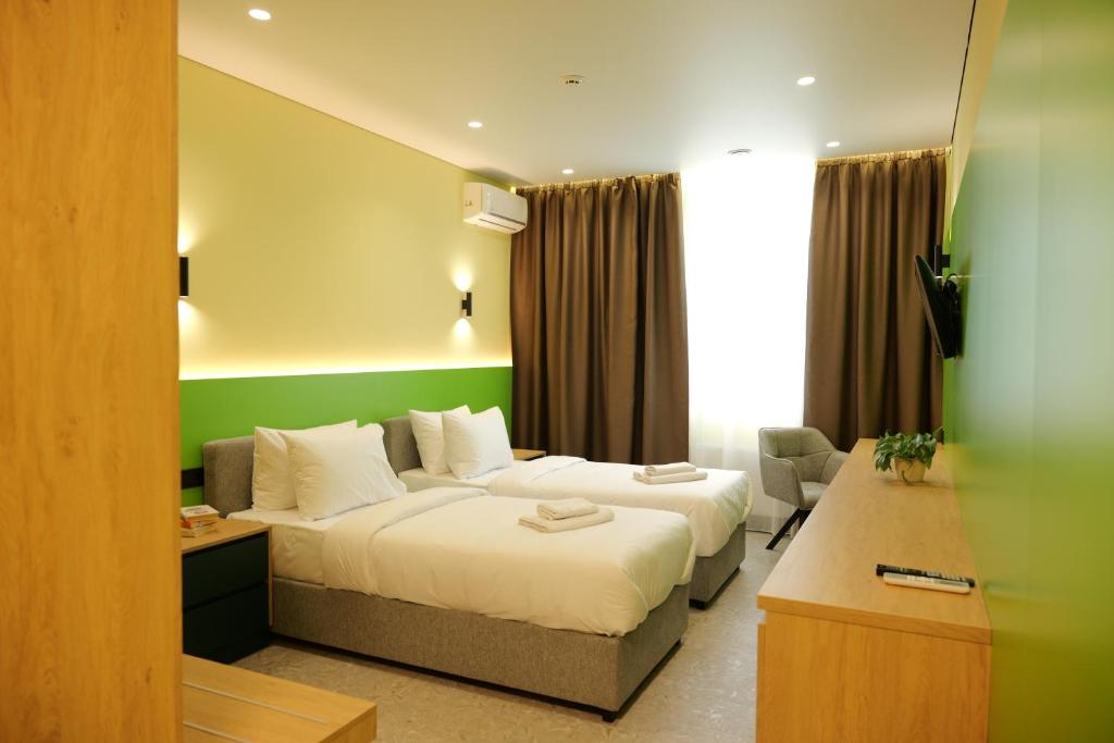 a hotel room with two beds and a couch at BVS Hotel in Ukrayinka