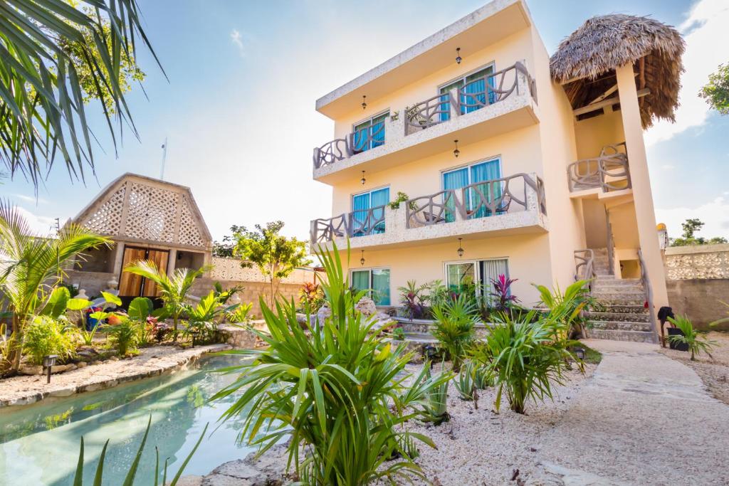 an exterior view of a house with a swimming pool at Jaakbal Tulum in Tulum