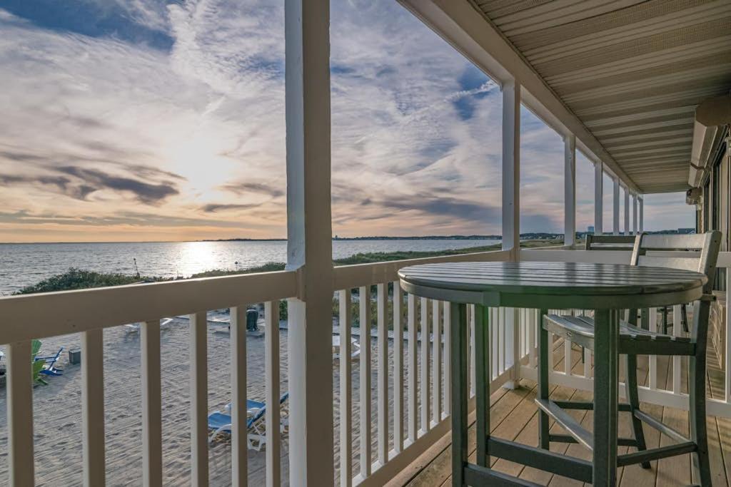 a balcony with a table and a view of the ocean at Oceanfront hideaway with full kitchen AC sunrise-view balcony in North Truro