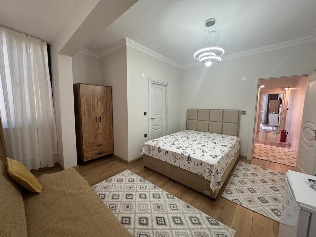 a large room with two beds and a mirror at Mürefte Suite in Tekirdağ