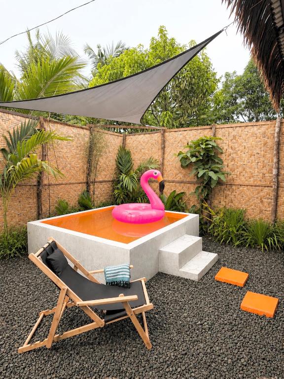 a pool with a pink flamingo and a chair at Casa Paco Siargao in Catagnan